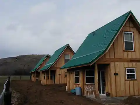 Green metal roofs on log and cedar cabins