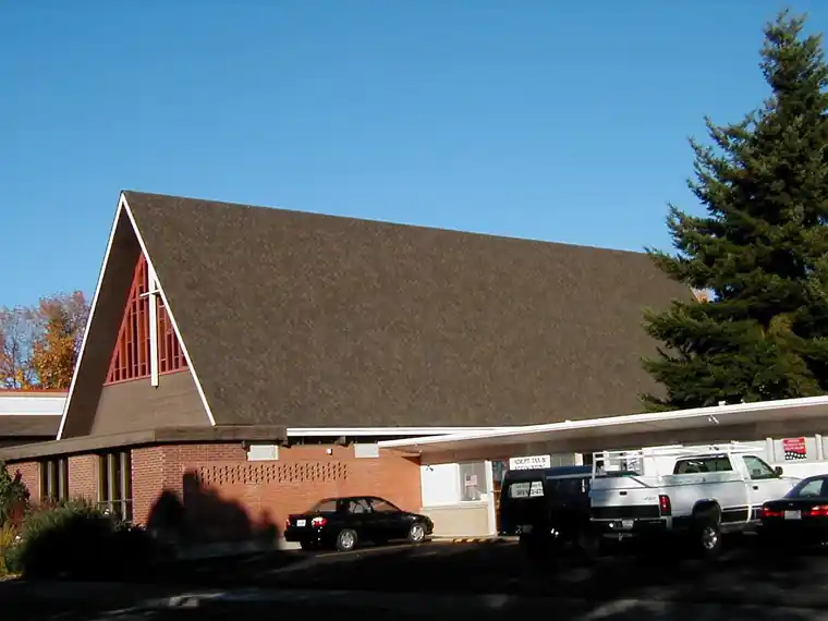 A-frame church with a new brown shingle roof