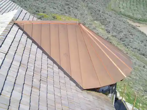 Copper turret detail above slate-look shingle