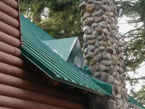 Log and cedar cabins with green metal roofs