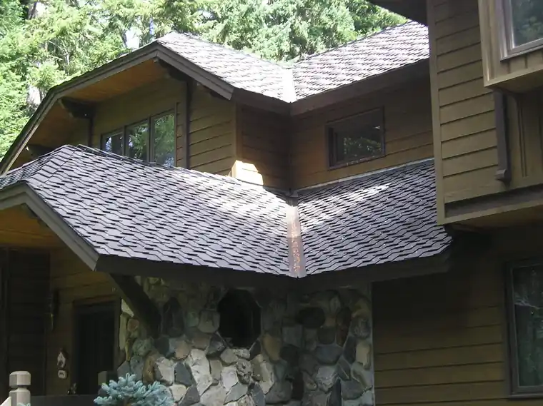Architectural shingle dormer above river-rock siding