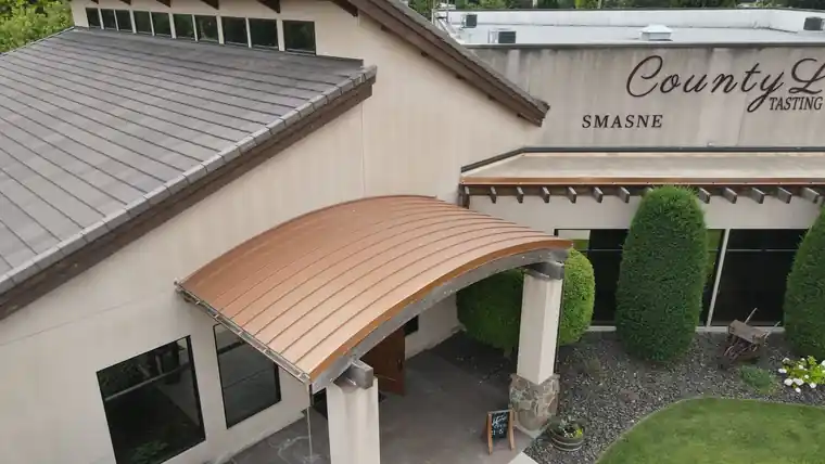 Curved copper awning over a winery tasting room entrance